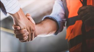 Shopfitting contractor and customer shaking hands